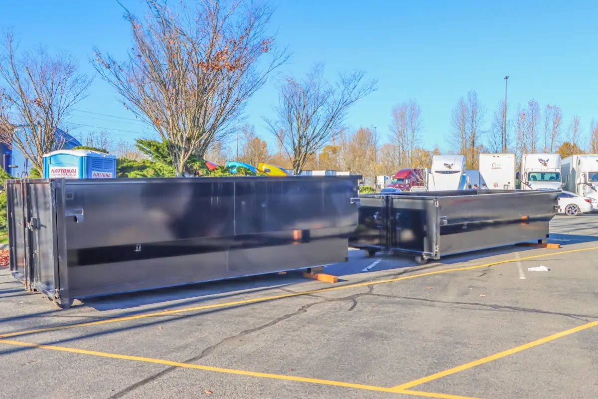 Professional dumpster rental service with roll-off container on residential driveway in Connellsville